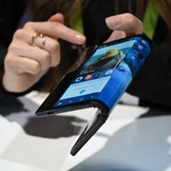 The folding and capabilities of the Royole FlexPai tablet and phone are demonstrated at the Royole booth at CES 2019 consumer electronics show, January 8, 2019 at the Las Vegas Convention Center in Las Vegas, Nevada.