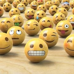 Emoji aus Holzbällen zeigen verschiedene Emotionen